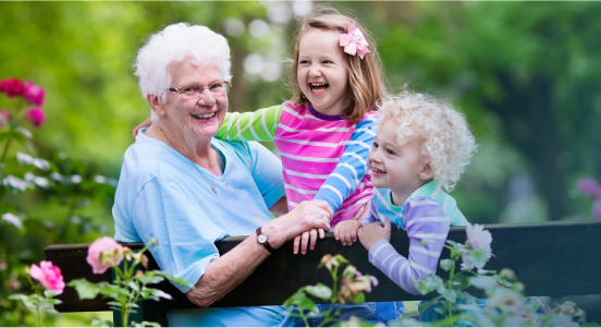 A grandma playing with her two young grandchildren.